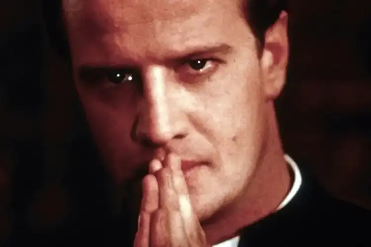 To kill a priest movie where Chrstiopher Lambert is praying